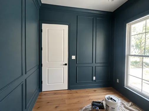 Illustrative blue-green paneled room after a wall finish